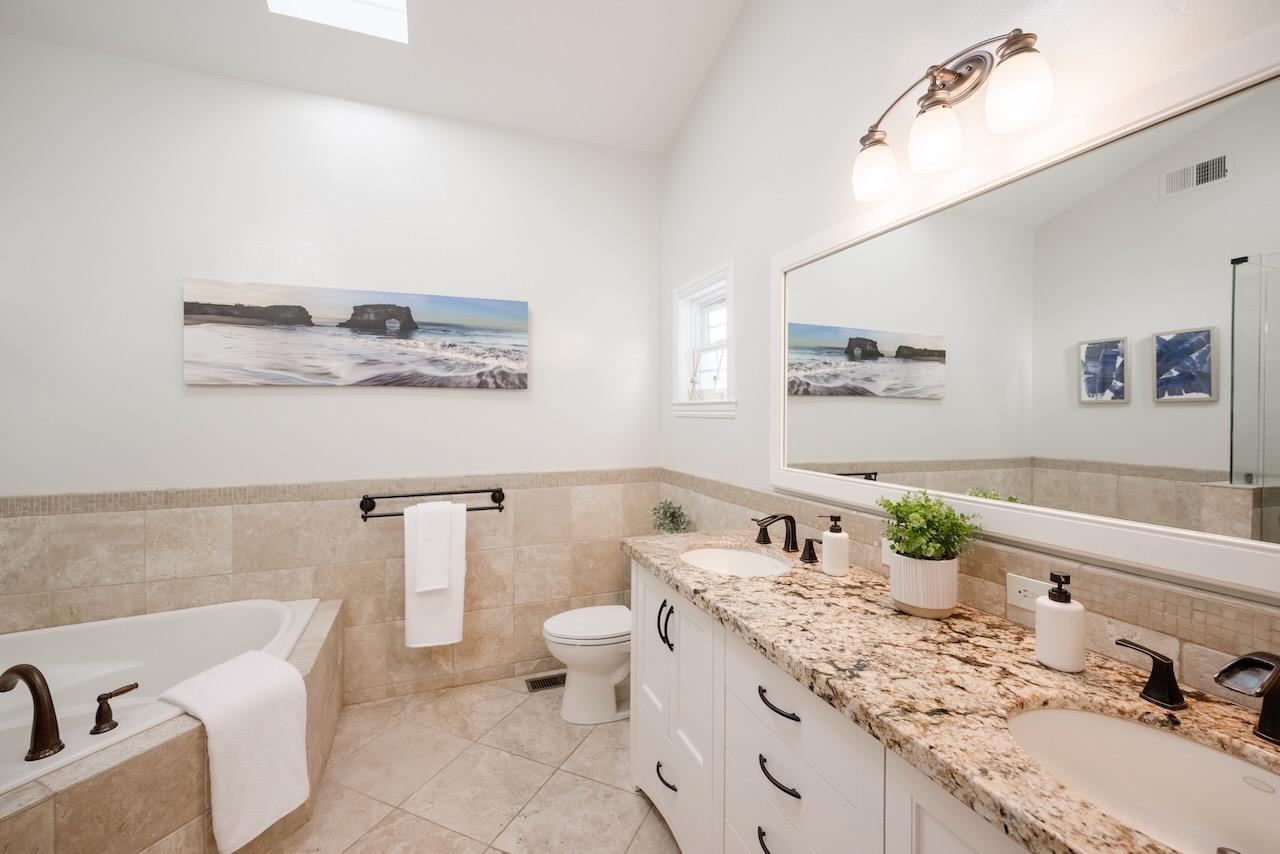 145 Rabbits Run Road Santa Cruz, CA 95060 - Photo 51 of 120 a bathroom with a granite countertop sink and a mirror