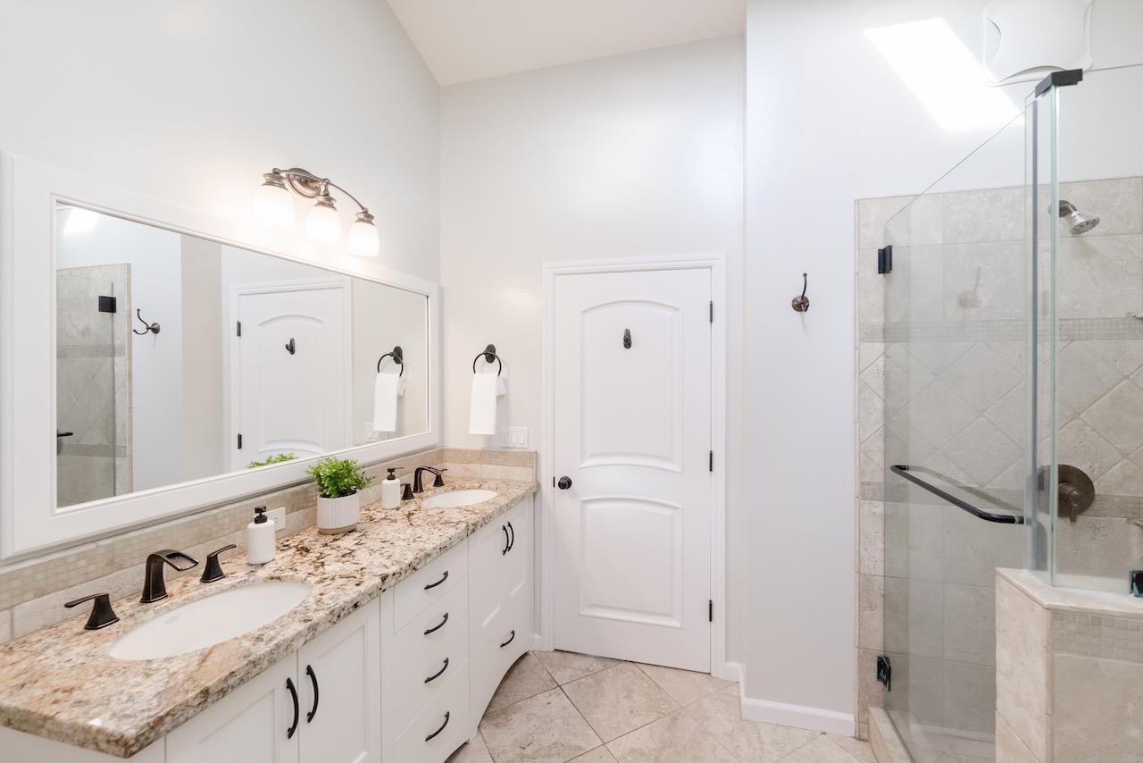 145 Rabbits Run Road Santa Cruz, CA 95060 - Photo 56 of 120 a bathroom with a granite countertop sink and a mirror