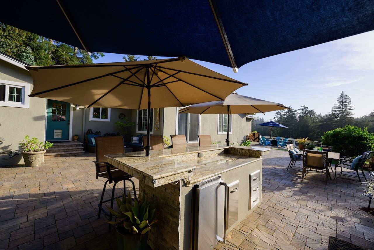 145 Rabbits Run Road Santa Cruz, CA 95060 - Photo 90 of 120 a view of a patio with chairs and table under an umbrella