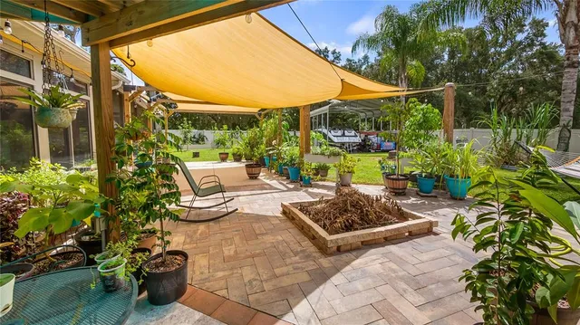 a view of a patio with table and chairs potted plants