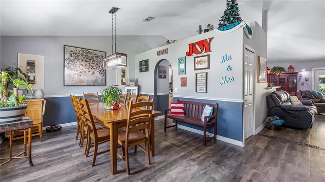 a view of a dining room with furniture kitchen and wooden floor