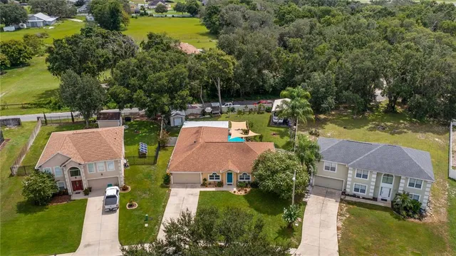 a view of a yard in front of a house with green space