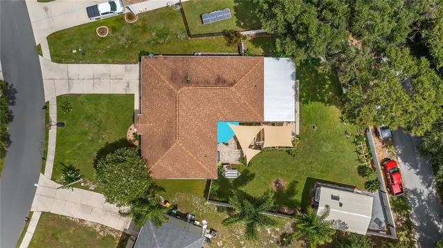 an aerial view of residential houses with outdoor space and lake view