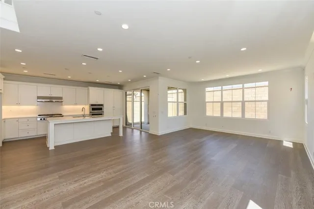 a view of kitchen with sink and wooden floor