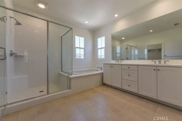 a spacious bathroom with a mirror a shower and a sink