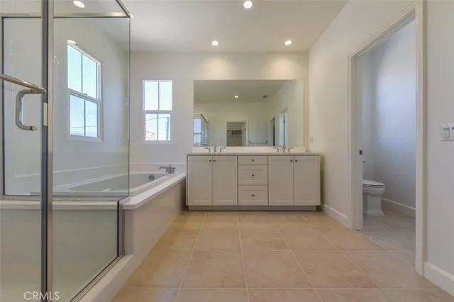 a bathroom with a granite countertop sink a toilet and mirror
