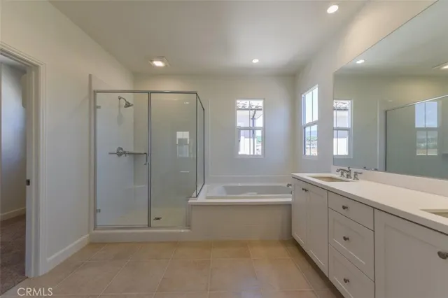 a spacious bathroom with a mirror a shower and a bathtub