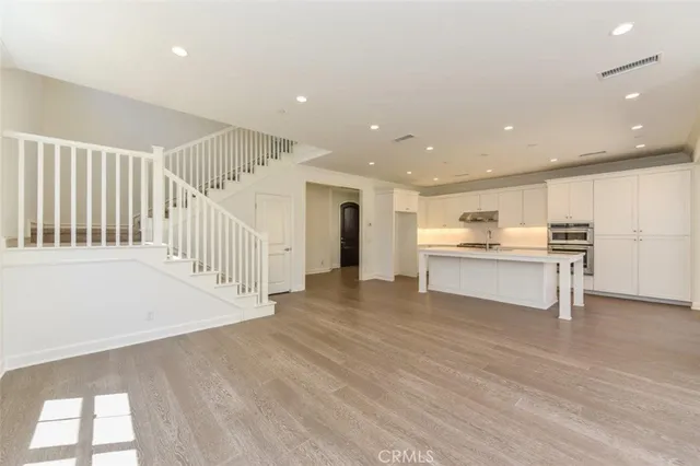 a view of kitchen with wooden floor and electronic appliances