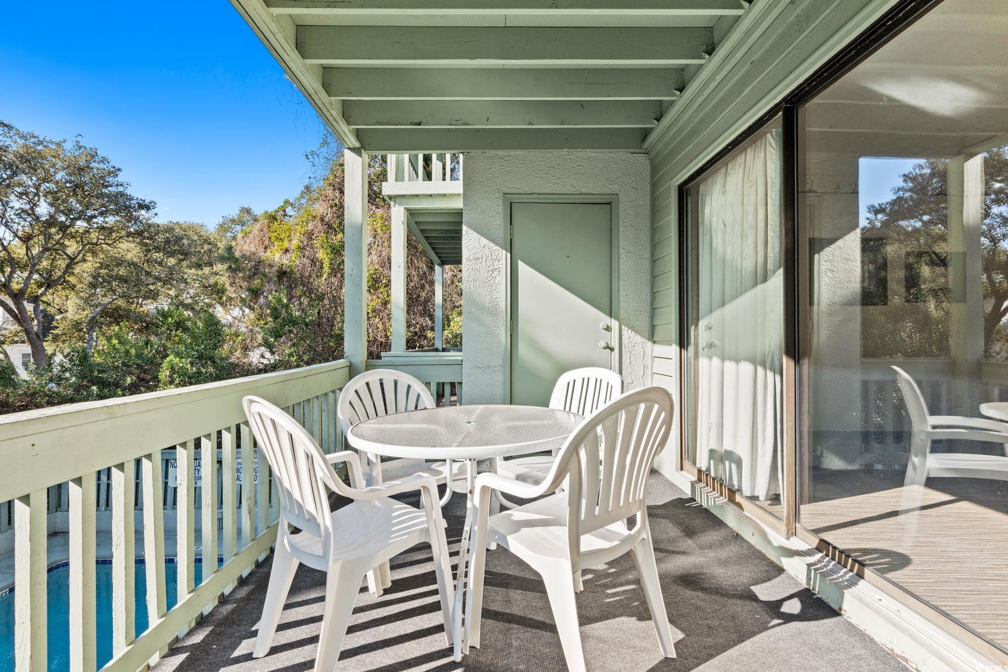 307 70th Avenue North, Unit 202 Myrtle Beach, SC 29572 - Photo 18 of 33 Balcony featuring outdoor dining space