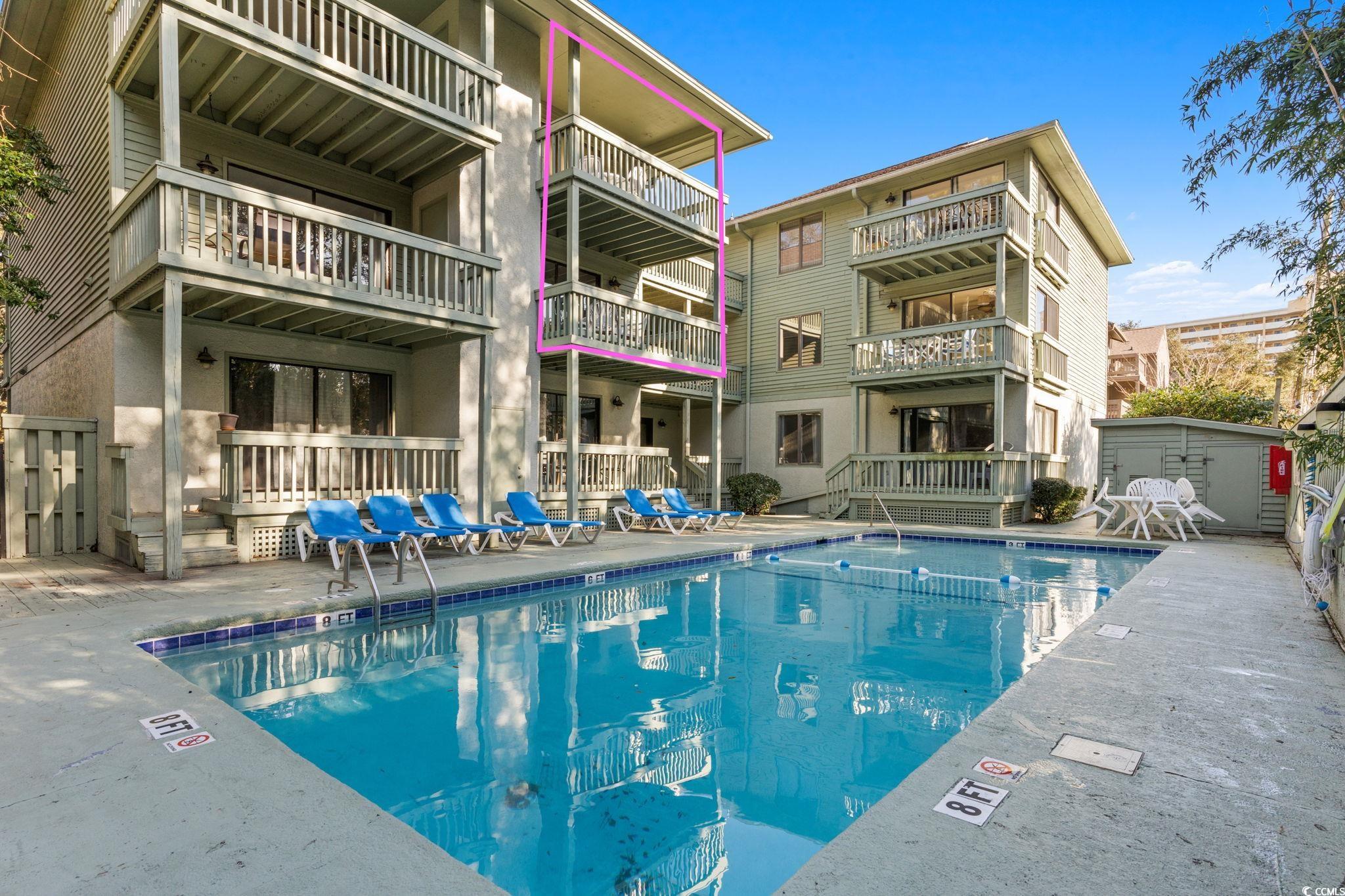 307 70th Avenue North, Unit 202 Myrtle Beach, SC 29572 - Photo 29 of 33 Community pool featuring a patio area and an outdoor structure
