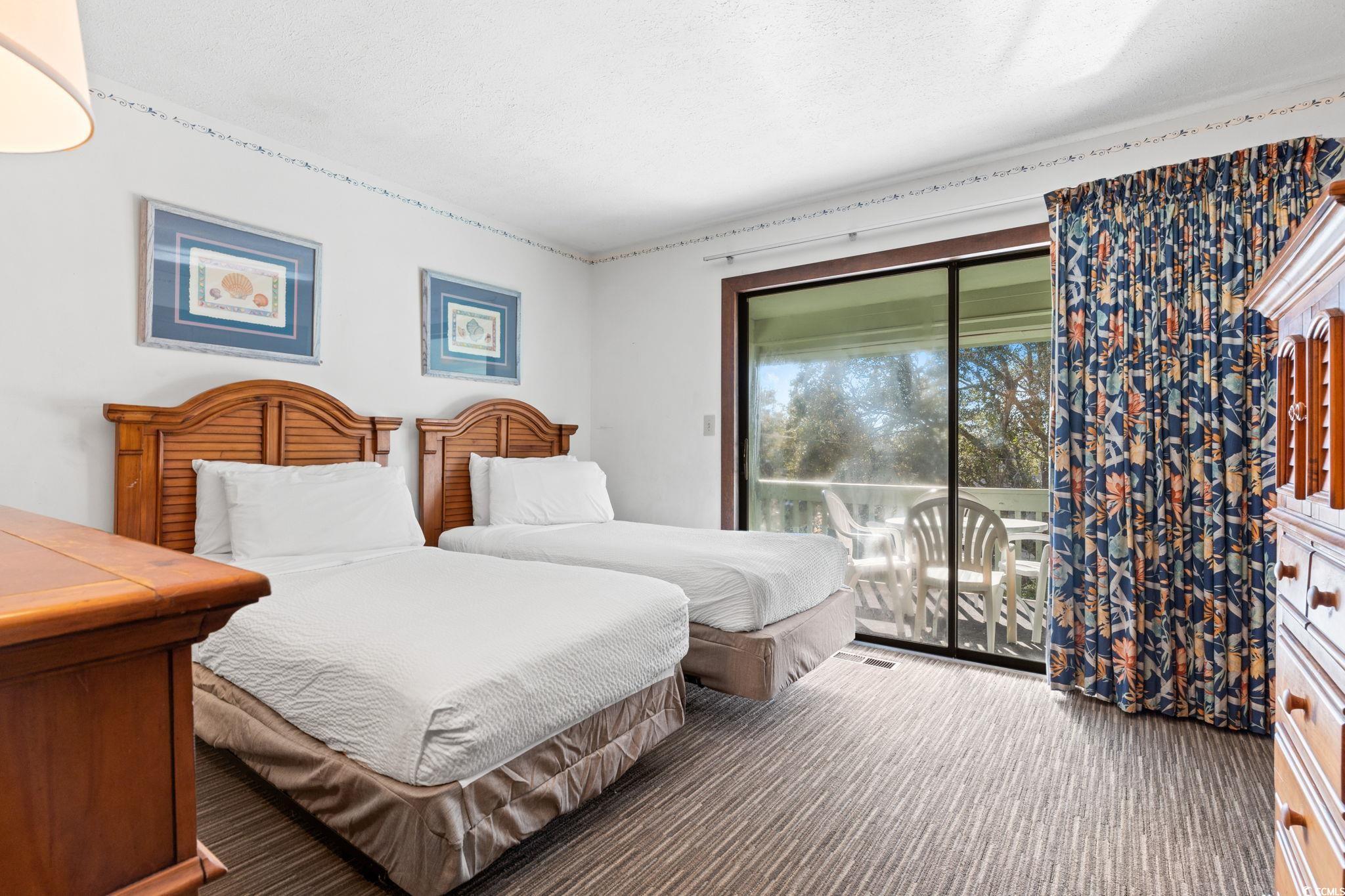 307 70th Avenue North, Unit 202 Myrtle Beach, SC 29572 - Photo 10 of 33 Bedroom featuring access to outside and carpet