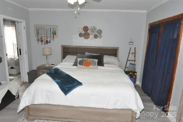 a bedroom with a large bed and a chandelier