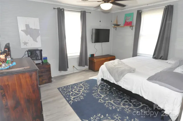 a bedroom with a bed and a television