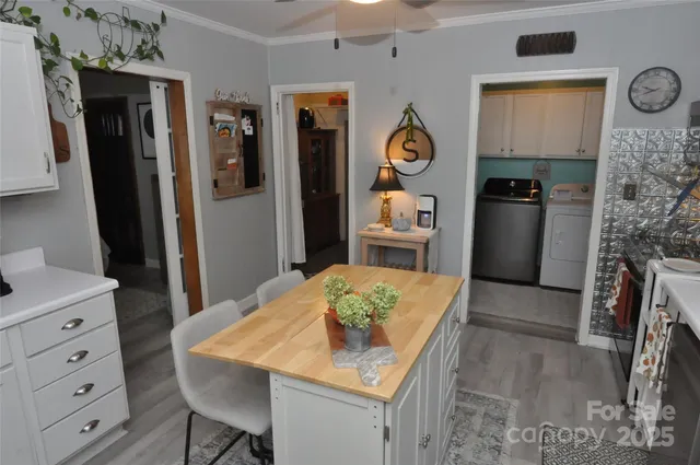 a kitchen with stainless steel appliances kitchen island granite countertop a refrigerator a stove a microwave oven with a dining table and chairs