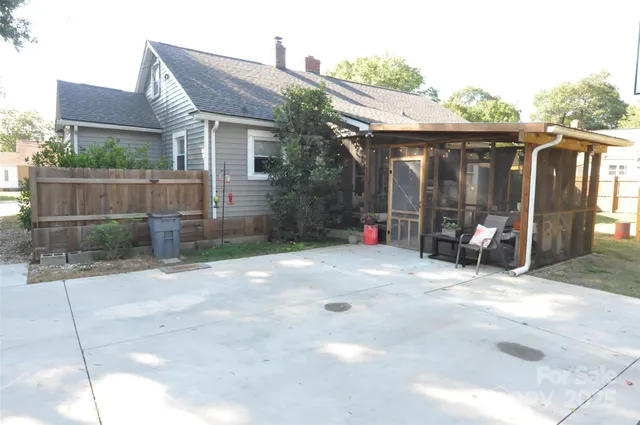 a view of a chair and table in backyard of the house
