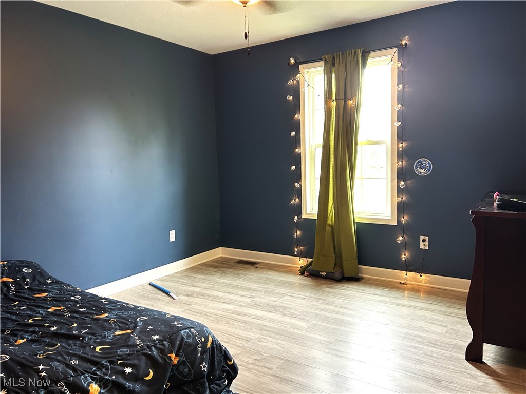 5320 Boston Road Brunswick, OH 44212 - Photo 9 of 18 Bedroom featuring baseboards and light wood-type flooring