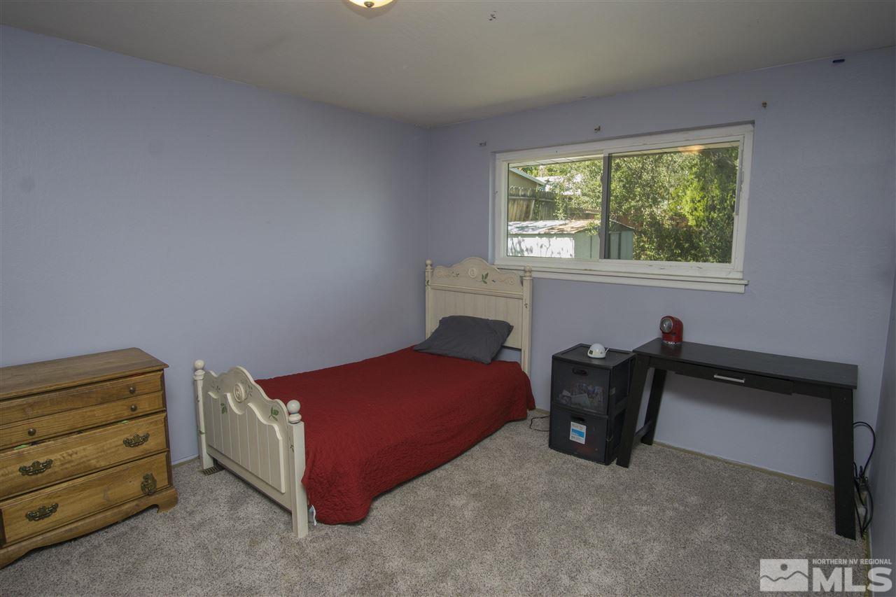 2245 West 6th Street Reno, NV 89503 - Photo 13 of 24 a bedroom with a bed and a window