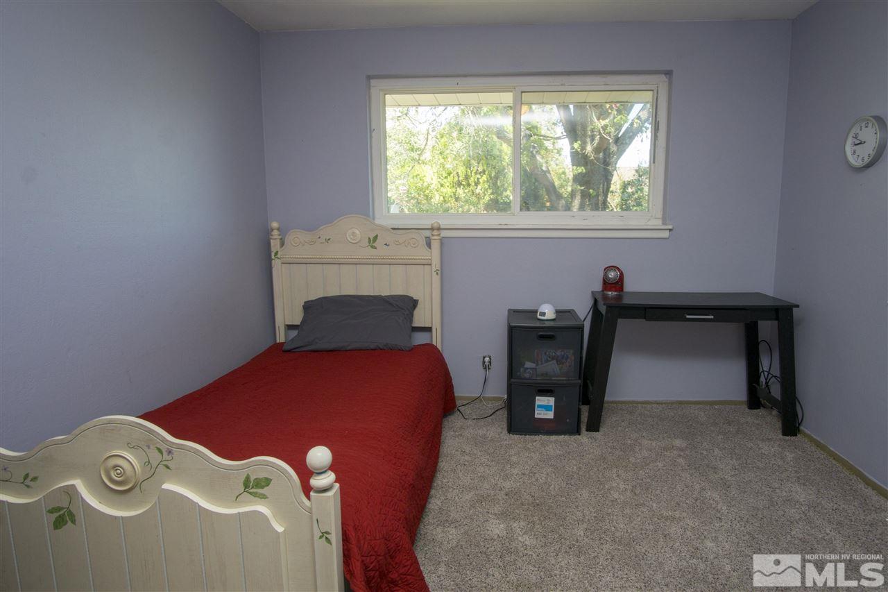 2245 West 6th Street Reno, NV 89503 - Photo 14 of 24 a bedroom with a bed and a window