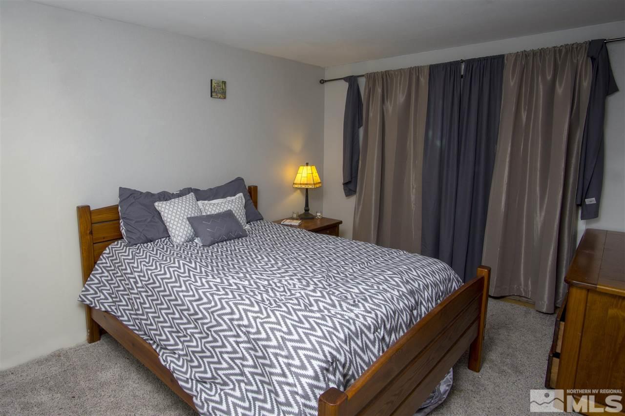 2245 West 6th Street Reno, NV 89503 - Photo 19 of 24 a bedroom with a bed and a lamp