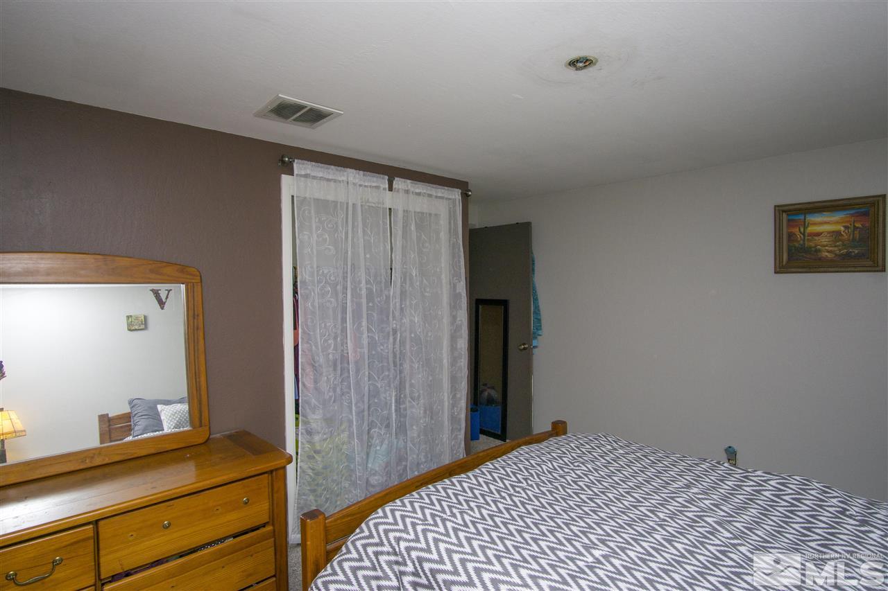 2245 West 6th Street Reno, NV 89503 - Photo 20 of 24 a bedroom with a bed and a dresser in it
