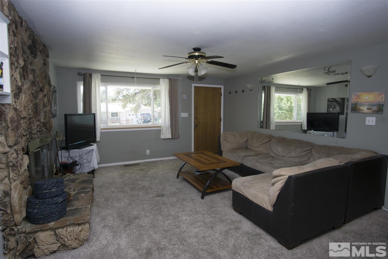2245 West 6th Street Reno, NV 89503 - Photo 5 of 24 a living room with furniture a fireplace and a flat screen tv
