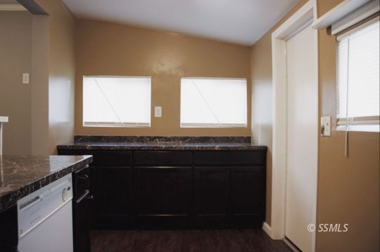 420 South Sunset Street Ridgecrest, CA 93555 - Photo 4 of 18 a kitchen with a sink and a mirror