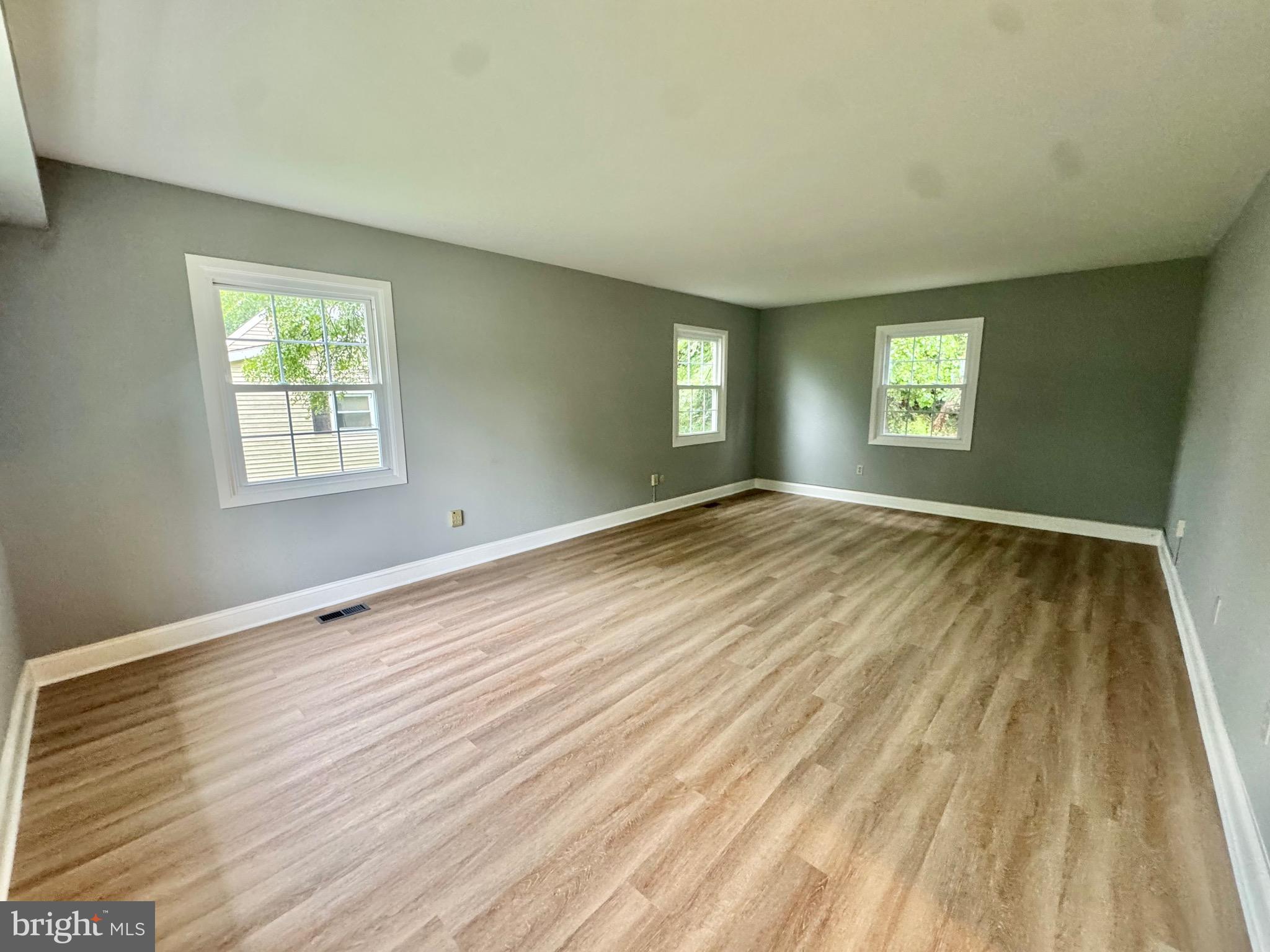 4908 Rocky Spring Lane Bowie, MD 20715 - Photo 5 of 36 a view of empty room with wooden floor and fan