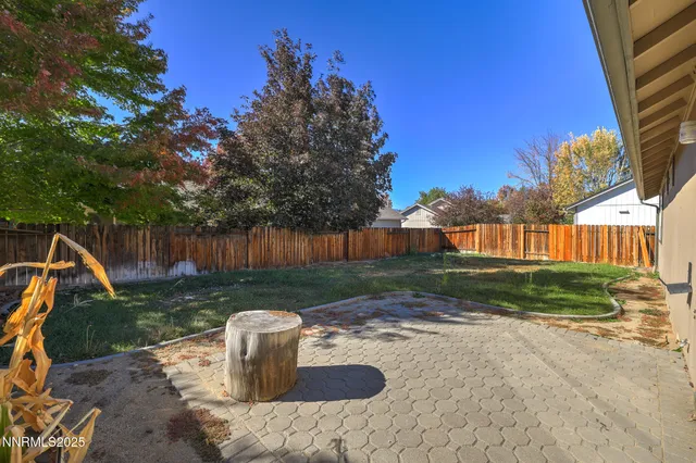 a backyard of a house with table and chairs