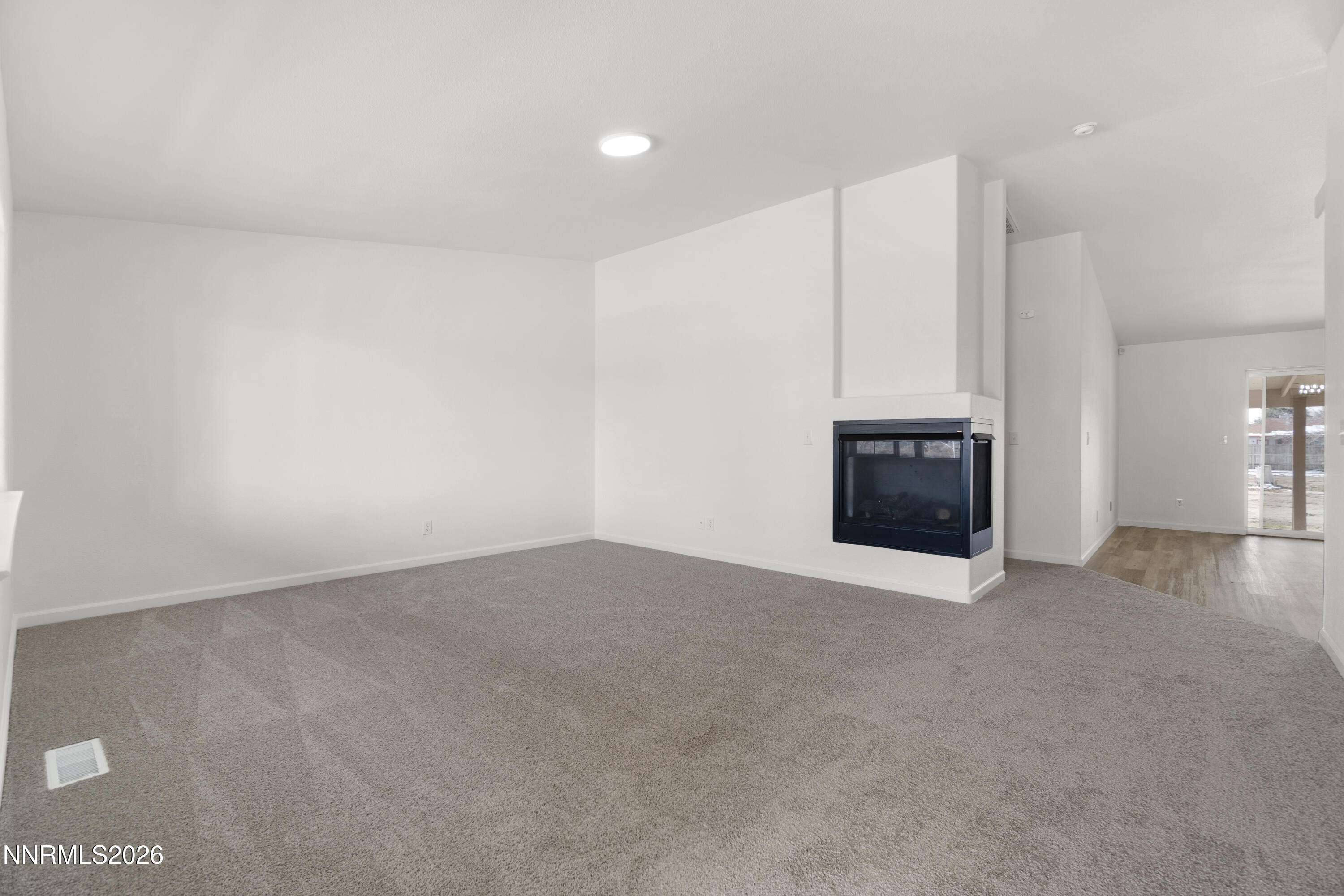 4015 Raven Drive Fallon, NV 89406 - Photo 7 of 29 a view of an empty room with a fireplace