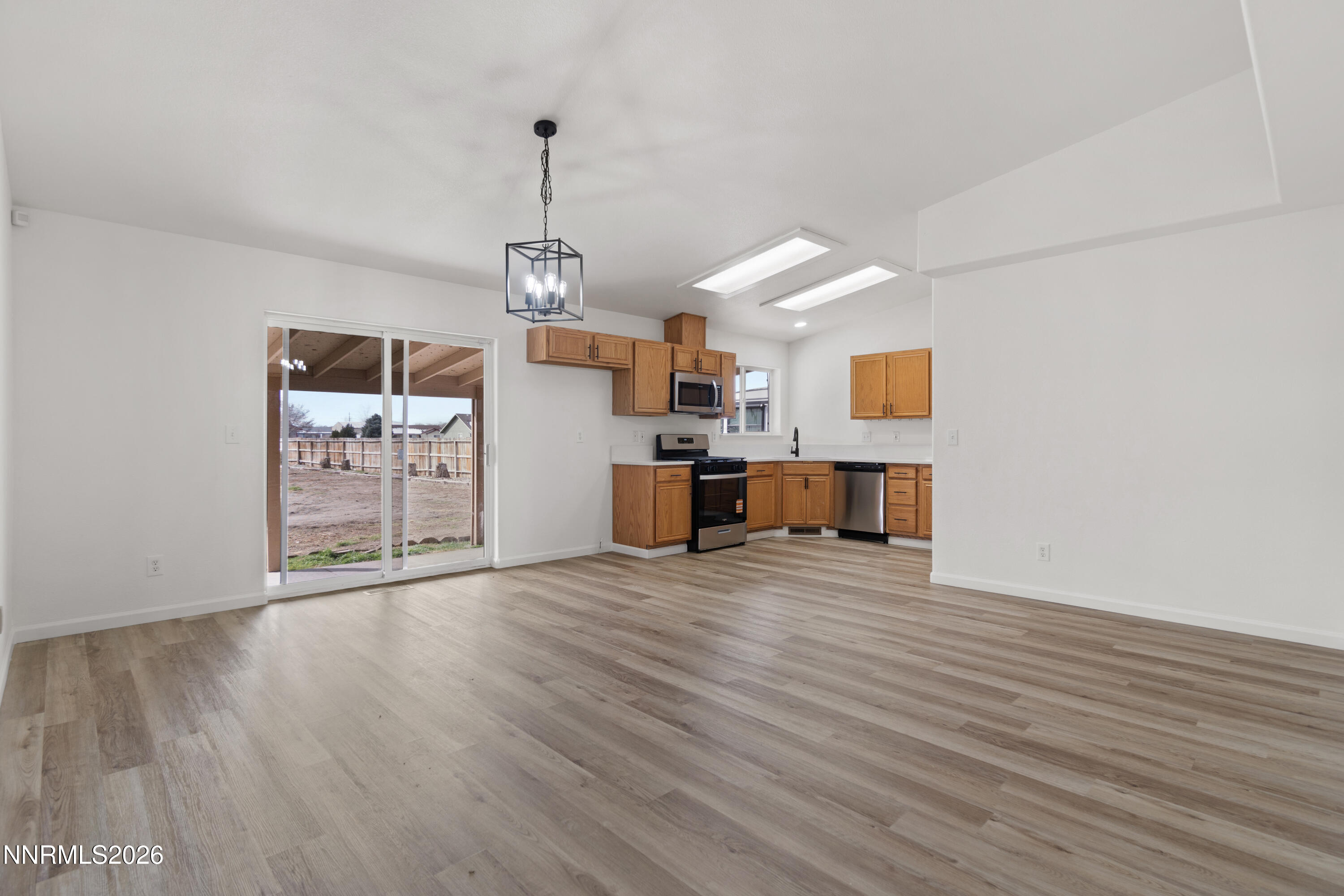 4015 Raven Drive Fallon, NV 89406 - Photo 9 of 29 a view of a kitchen with wooden floor and a ceiling fan