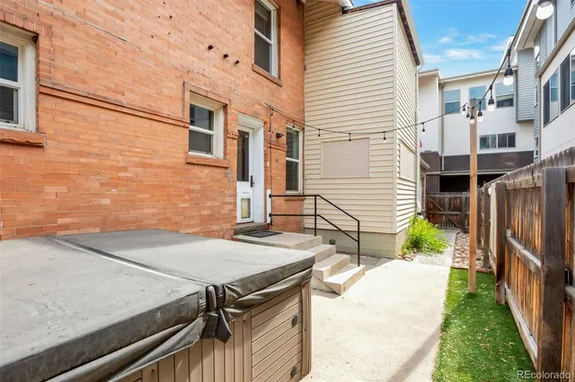 a view of house with backyard and sitting area
