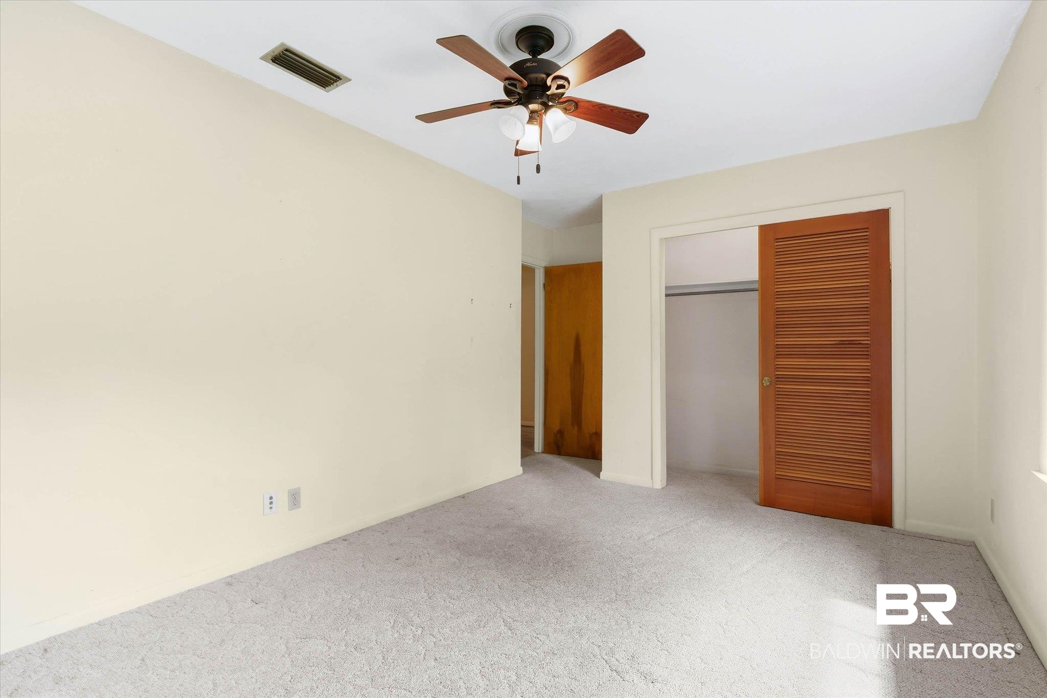1182 Ginger Drive Mobile, AL 36693 - Photo 22 of 37 Carpeted room featuring a ceiling fan with integrated lighting, louvered closet doors, and recessed shelving