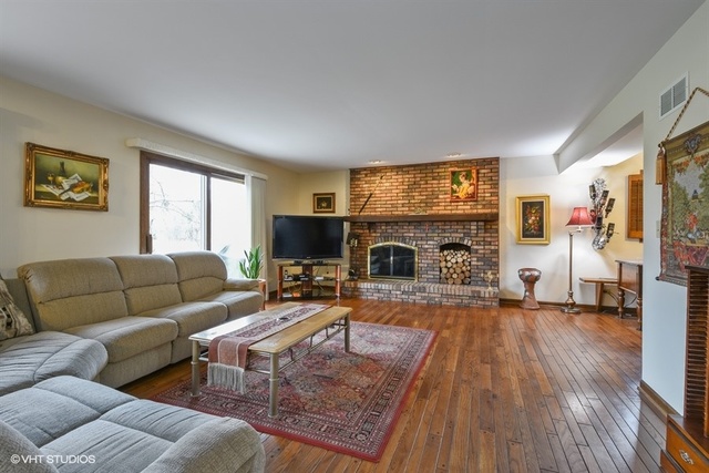 100 Ela Road Inverness, IL 60067 - Photo 3 of 25 a living room with furniture flat screen tv and a fireplace