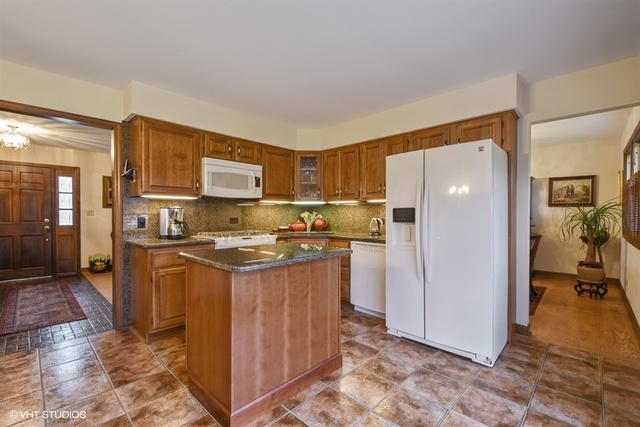 100 Ela Road Inverness, IL 60067 - Photo 6 of 25 a kitchen with stainless steel appliances granite countertop a refrigerator stove and a sink