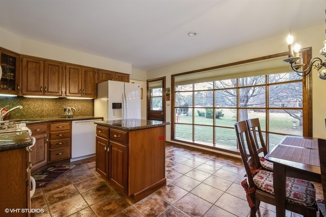 100 Ela Road Inverness, IL 60067 - Photo 8 of 25 a kitchen with a stove a refrigerator and wooden cabinets