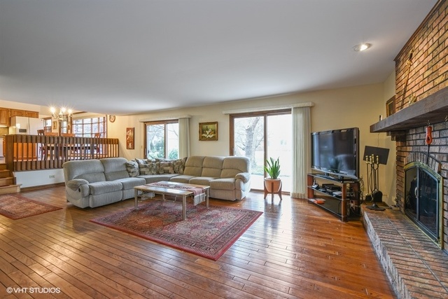100 Ela Road Inverness, IL 60067 - Photo 10 of 25 a living room with furniture wooden floor and a fireplace