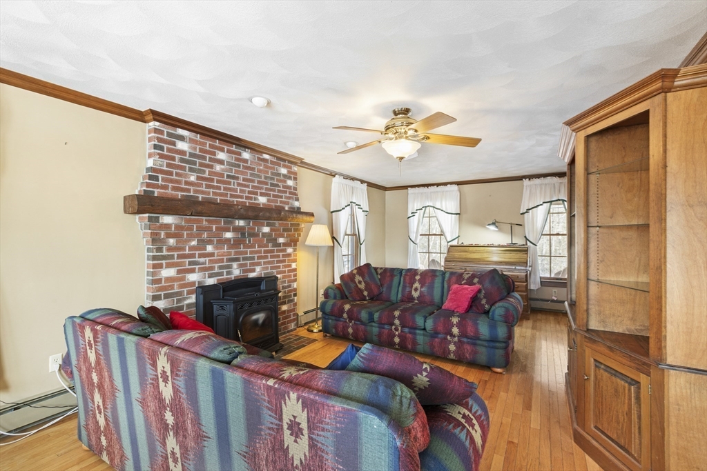 162 South Shore Road Burrillville, RI 02859 - Photo 12 of 39 a living room with furniture fireplace and a flat screen tv