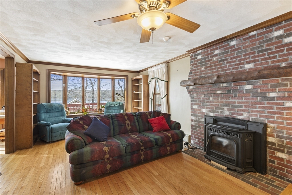 162 South Shore Road Burrillville, RI 02859 - Photo 13 of 39 a living room with furniture a flat screen tv and a fireplace