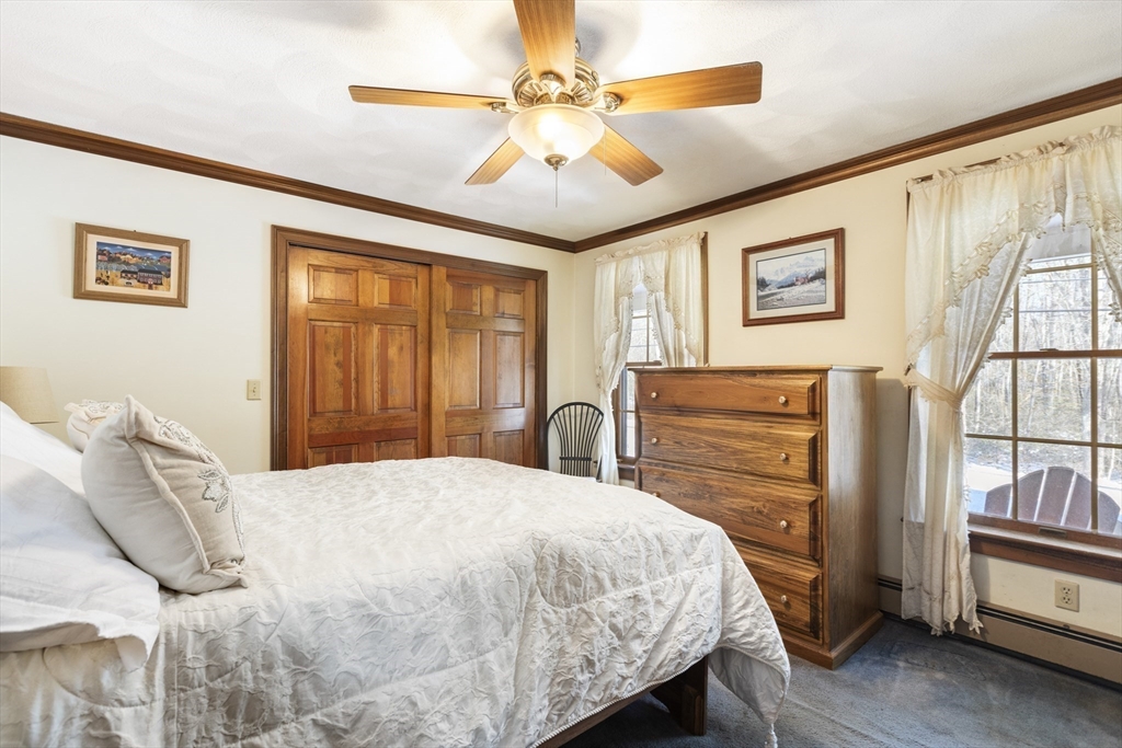 162 South Shore Road Burrillville, RI 02859 - Photo 21 of 39 a bedroom with a bed and a chandelier