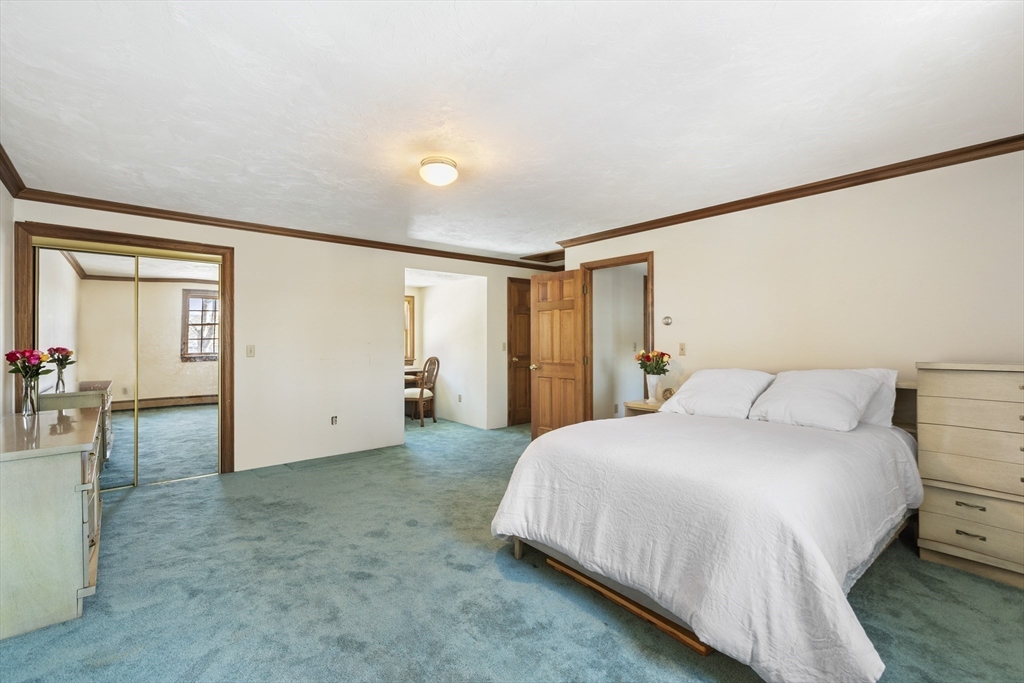 162 South Shore Road Burrillville, RI 02859 - Photo 28 of 39 a bedroom with a bed and a table