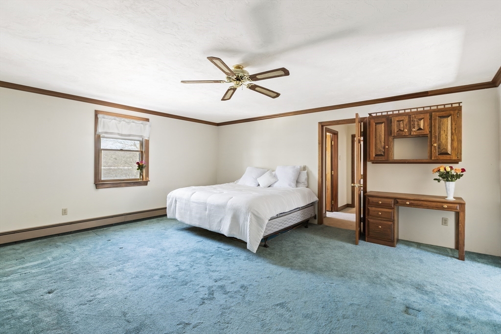 162 South Shore Road Burrillville, RI 02859 - Photo 30 of 39 a spacious bedroom with a bed and cabinets
