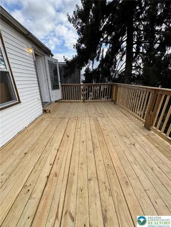 a view of deck with wooden floor and fence