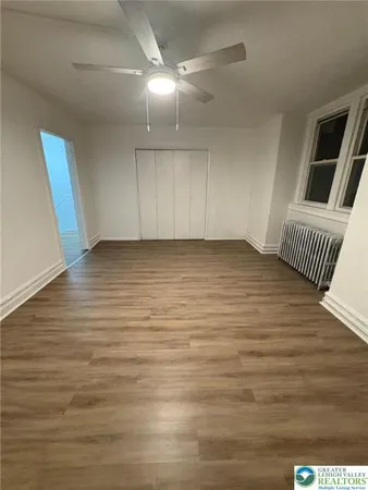 a view of room with window and hardwood floor