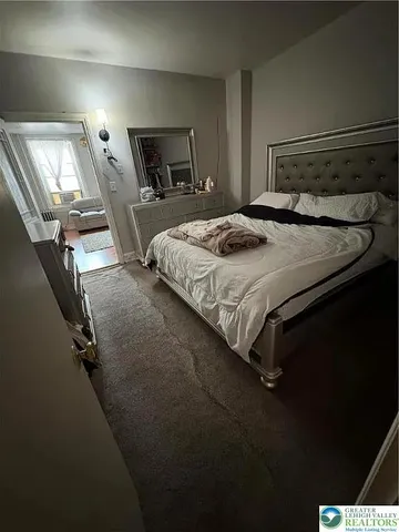 a bedroom with a bed and mirror