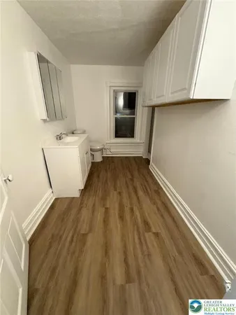 a view of a kitchen with wooden floor and a sink