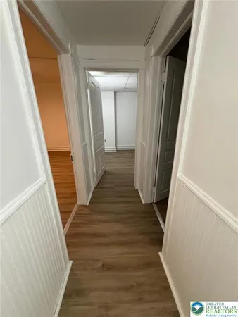 a view of a hallway with wooden floor and staircase