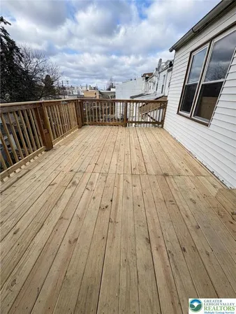 a view of balcony with wooden floor and fence