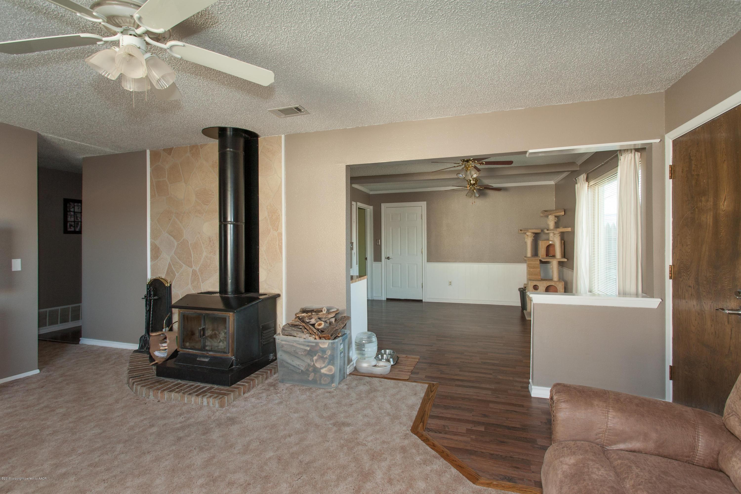 2418 Southwest 49th Avenue Amarillo, TX 79110 - Photo 4 of 30 a living room with furniture and a chandelier