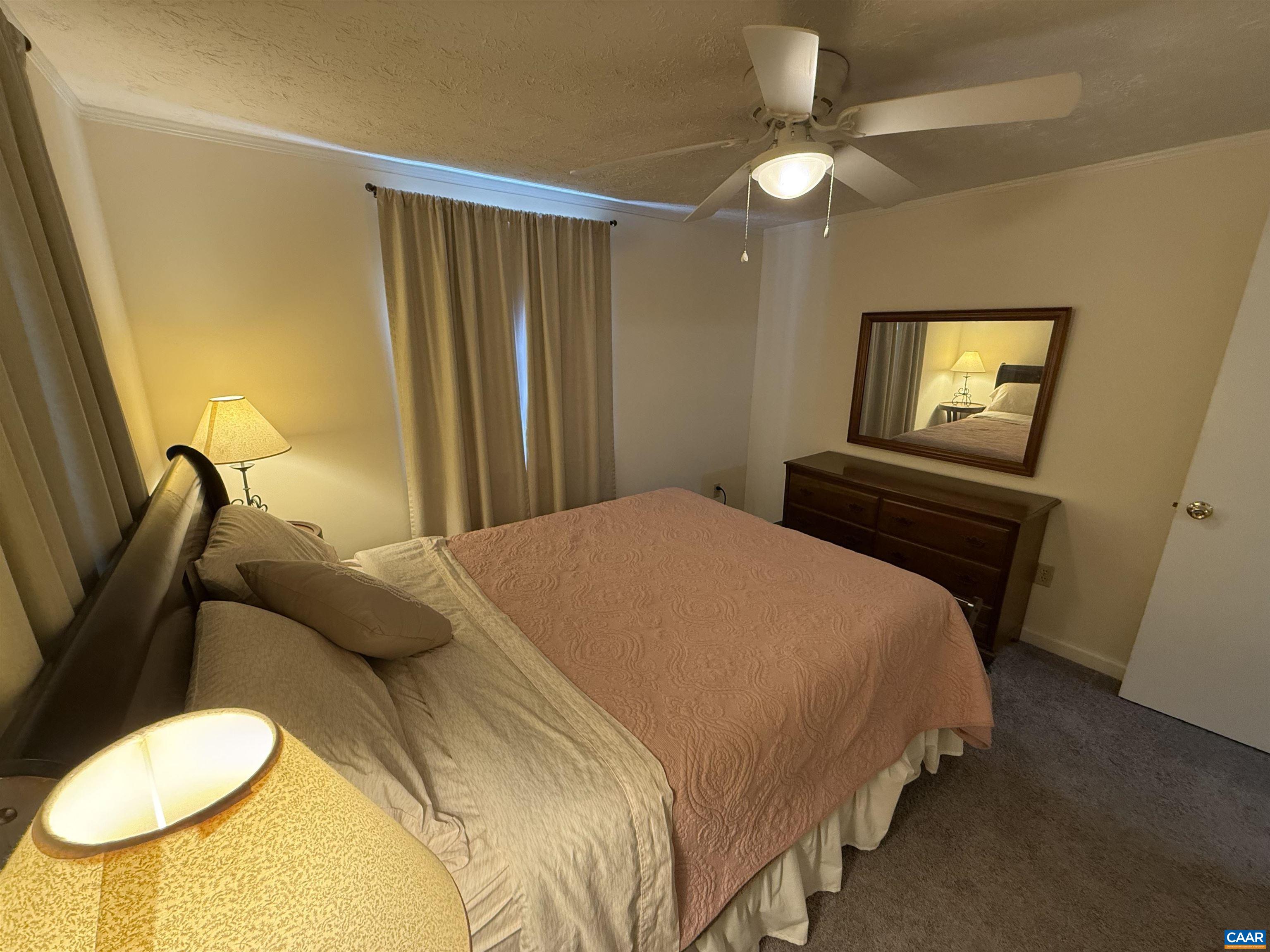 2002 Oliver Creek Road Troy, VA 22974 - Photo 21 of 38 a bedroom with a bed and a chandelier