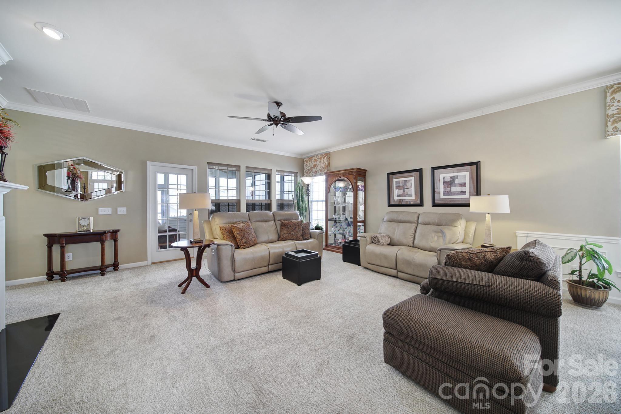 52083 Longspur Lane Fort Mill, SC 29707 - Photo 11 of 48 a living room with furniture and a dining table with window